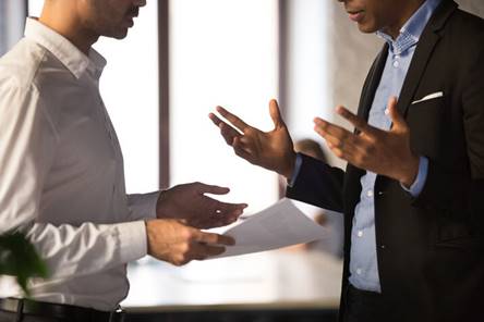 Man looking over paperwork with boss - Employment Law